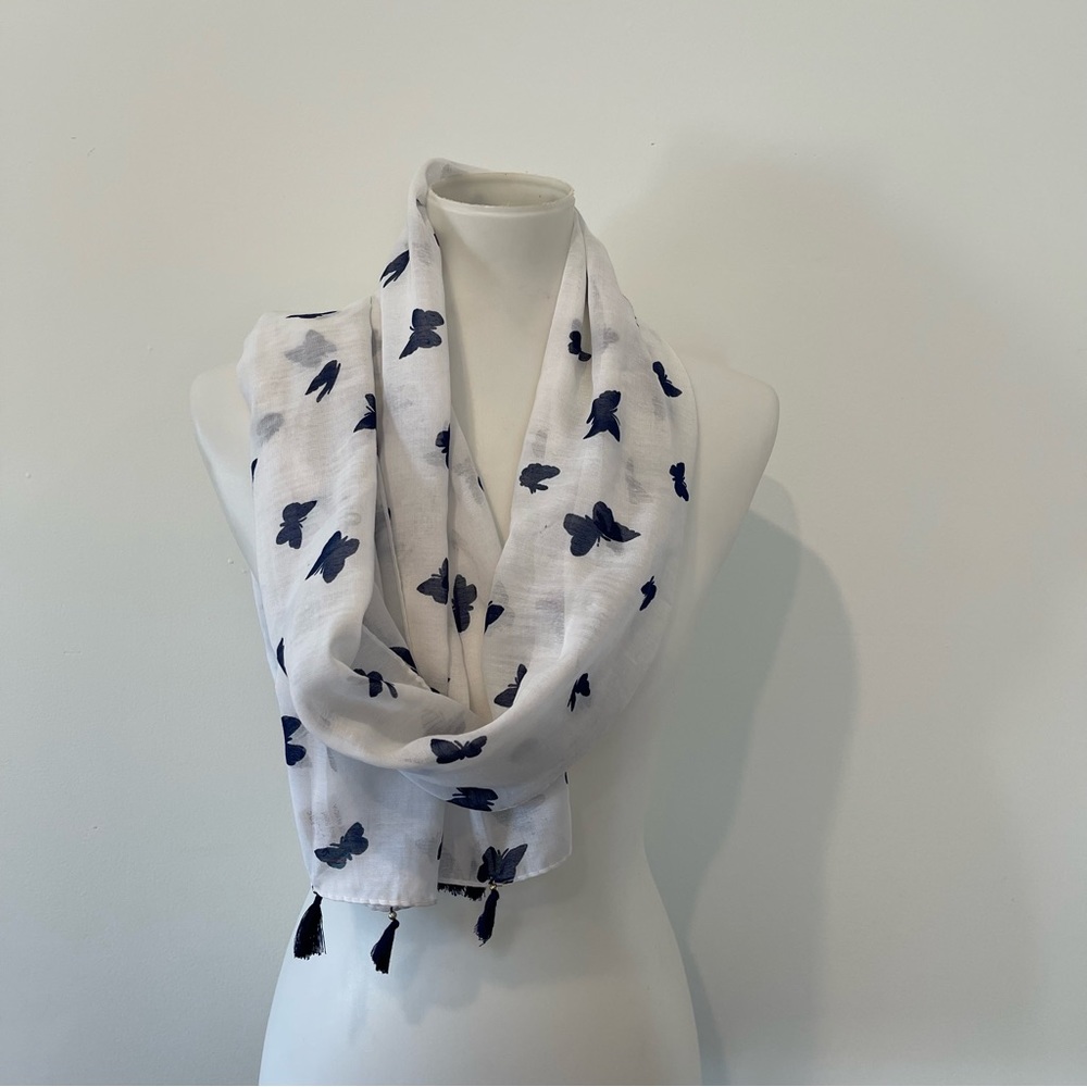 Lightweight scarf, white with blue butterflies and tassels.